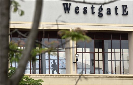 A Kenyan soldier runs through a corridor on an upper floor, shortly before an explosion was heard, at the Westgate Mall in Nairobi, Kenya Tuesday, Sept. 24, 2013. Kenya's president said the prolonged attack on the mall is over, leaving at least 240 people dead. (AP Photo/Ben Curtis)