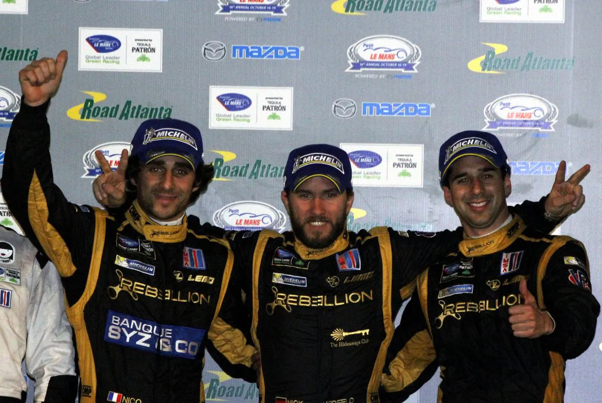 Nicolas Prost, Nick Heidfeld, and Neel Jani celebrate on the podium at Road Atlanta after winning the ALMS Petit Le Mans endurance race, Oct. 19, 2013. (Chris Jasurek/Epoch Times)