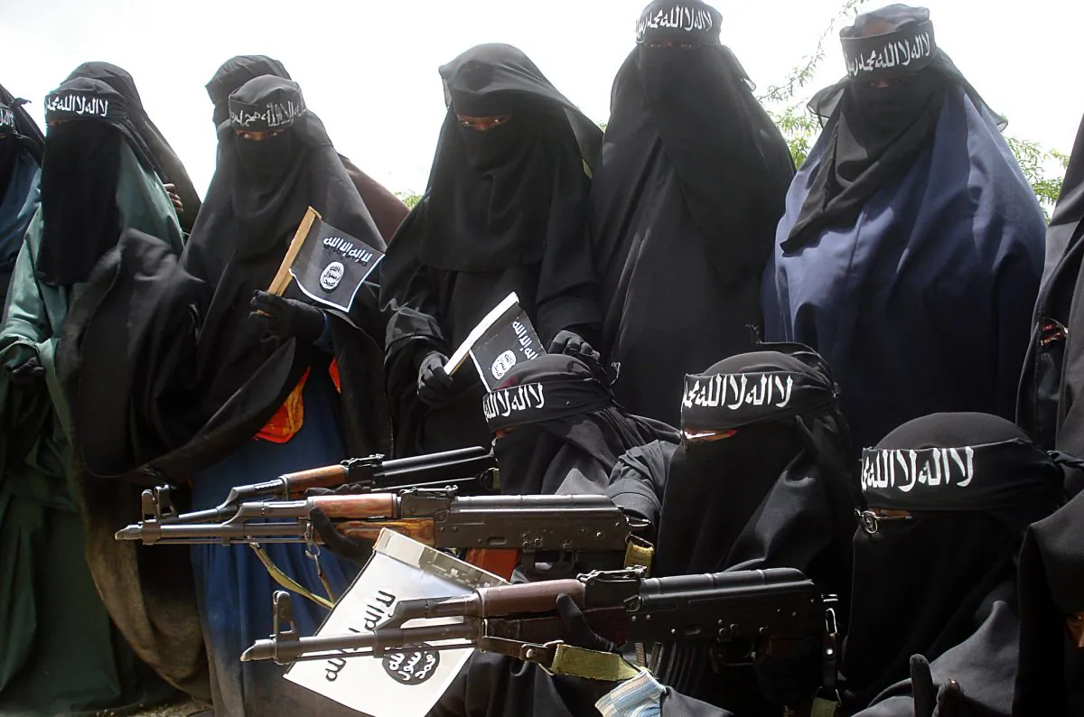 Somali women carry weapons during a demonstration organized by the extremist group al-Shabab in the Suqa Holaha neighborhood of Mogadishu, on July 5, 2010. (Abdurashid Abikar/AFP/File Photo via Getty Images)