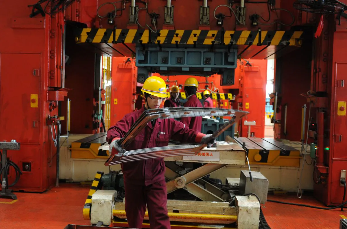 Chinese auto workers assemble vehicles at a car plant in Hefei, east China, March 9, 2012. (STR/AFP/Getty Images)