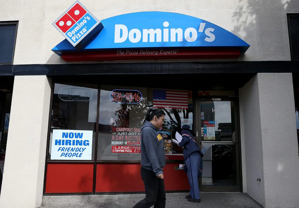 A 'Now Hiring' sign is posted in the window of a Domino's Pizza restaurant on in Albany, Calif., March 8. (Justin Sullivan/Getty Images)