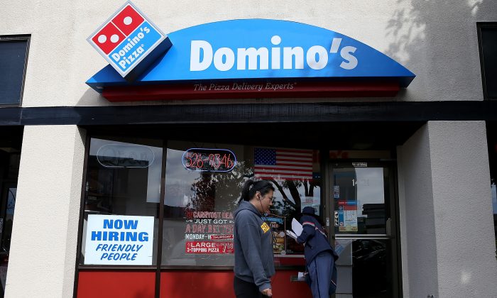 A 'Now Hiring' sign is posted in the window of a Domino's Pizza restaurant on in Albany, Calif., March 8. (Justin Sullivan/Getty Images)