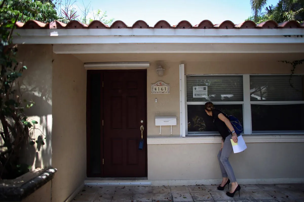 A real estate agent examines some property in this file photo. The biggest factors that affect the home appraisal include neighborhood, style of the home, and overall renovations. ( Joe Raedle/Getty Images)
