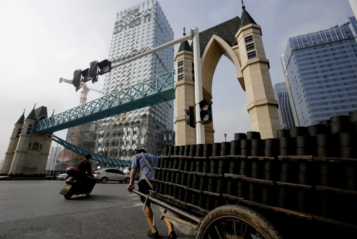 This picture taken on August 27, 2013 shows a man pulling a trolley filled with bricks outside a luxury hotel that is under construction in Wuhan, central China's Hubei province. Wuhan is well known for construction taking place all over the city, but it is now also known for high levels of debt. (STR/AFP/Getty Images)