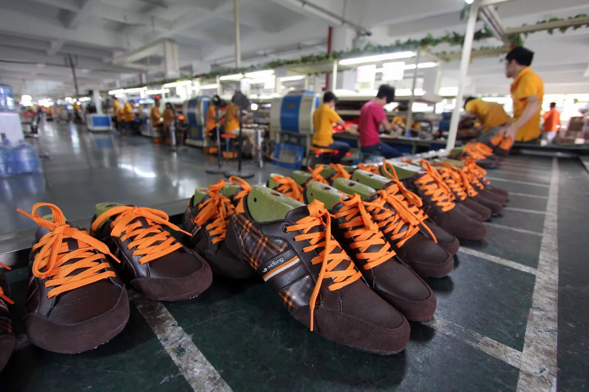 Laborers work in a shoe factory in Jinjiang, in southern China's Fujian Province on Sept. 17, 2013. In a recent report the financial Consulting firm Deloitte says that due to China's slower economic growth, its domestic manufacturing sector is facing a cold winter. (STR/AFP/Getty Images)