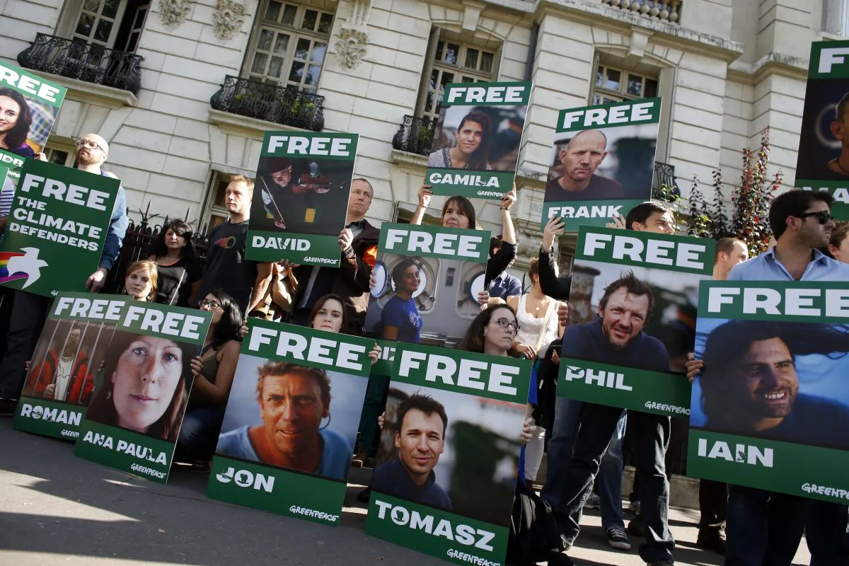 Greenpeace activists protest on Sept. 27 in front of the Russian embassy in Paris, with signs calling for the release of 30 activists from 18 countries arrested while protesting against the extraction of oil in the Arctic. One Australian citizen, Colin Russell, and another Australian resident are among the activists held without charges in a Russian prison. (Thomas SamsonAFP/Getty Images)