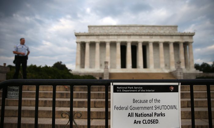 A U.S. Park Police officer stands guard in front of the closed Lincoln Memorial, Oct. 1, 2013 in Washington, D.C. Despite being shut out of their favorite public monuments, Chinese tourists are learning about America's independence from its government. (Mark Wilson/Getty Images)