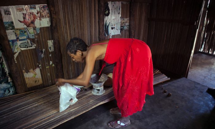 Sebastian Judalet and Roberto Gianfala were killed by a mob in Madagascar. A woman works on October 6, 2013 inside the small hut Roberto Gianfala rented before he was lynched on October 3, by a furious mob which suspected him of killing a boy. (Rijasolo/AFP/Getty Images)