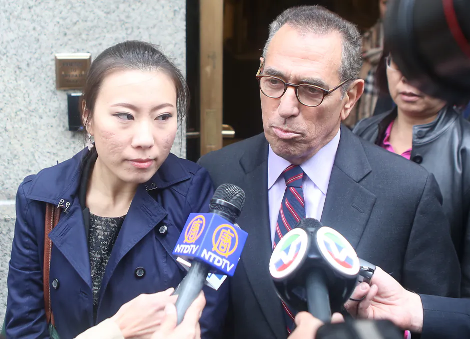 Comptroller John Liu’s former treasurer, Jenny Hou (L), exits the United States District Court in Manhattan with her lawyer, Jarold Lefcart, in New York, Oct. 10, 2013. (Gary Du/Epoch Times)