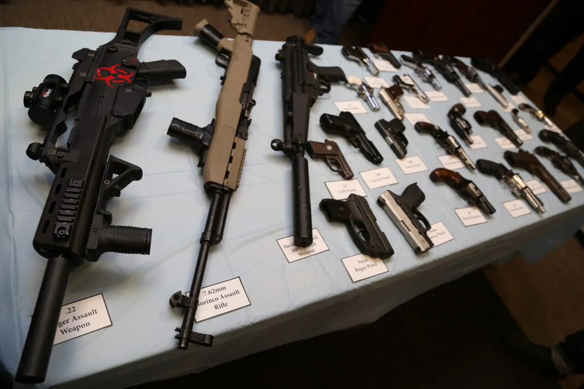 Illegally trafficked guns, including rifles, revolvers and pistols, displayed at the Kings County District Attorney's Office, in Brooklyn on Oct. 16, 2013.
(Christian Watjen/The Epoch Times)
