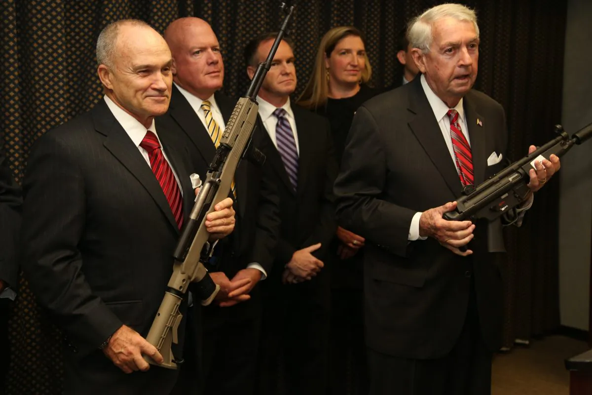 NYPD Commissioner Ray Kelly (L) and Kings County District Attorney Charles J. Hynes hold seized guns at the Kings County District Attorney's Office, Brooklyn, New York, Oct. 16, 2013. Christopher “Country” McPhaul, 43, was indicted for illegally selling 30 firearms to an undercover police officer in Brooklyn. (Christian Watjen/Epoch Times)