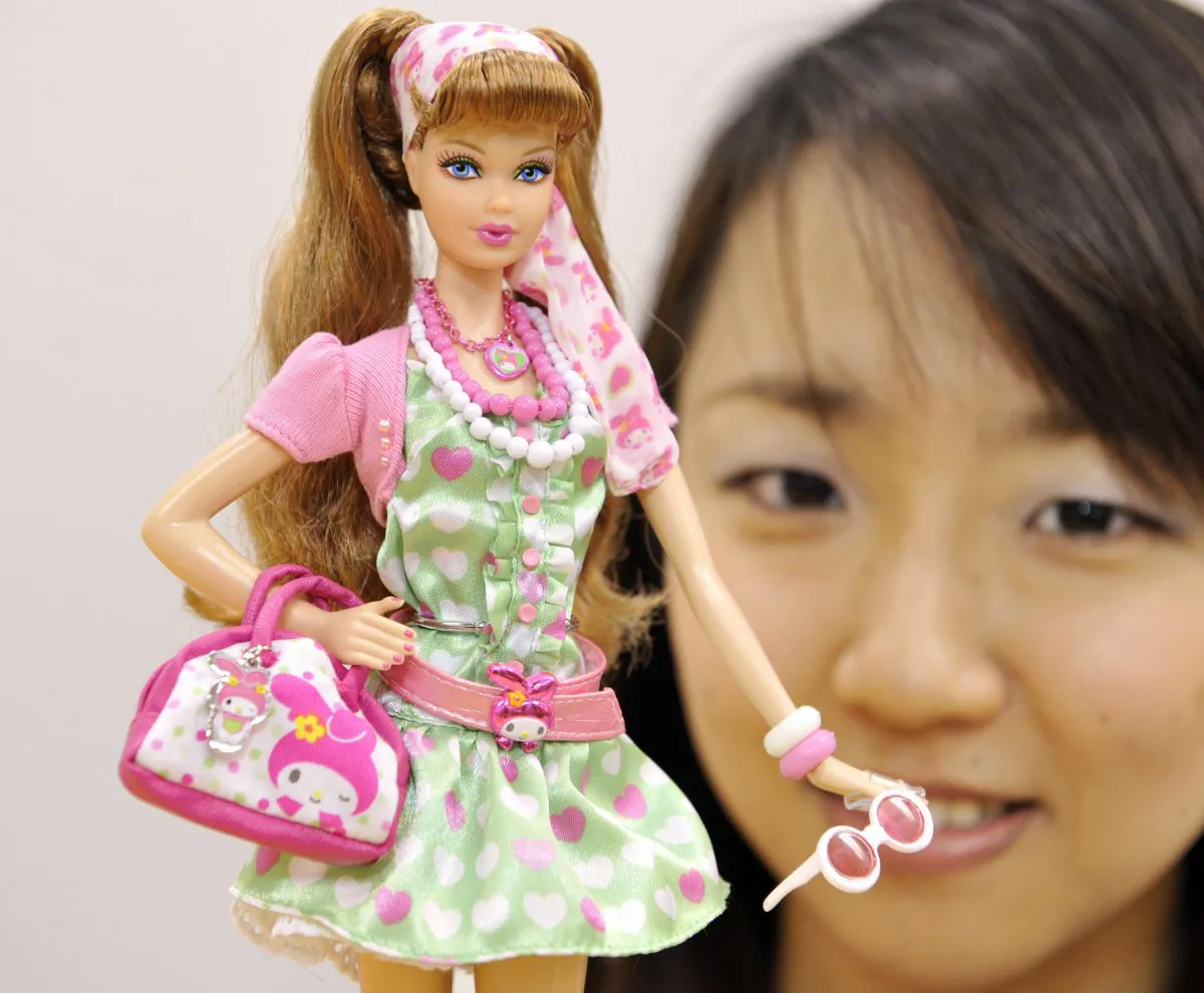 An employee of Mattel’s Japanese subsidiary Mattel International displays a Barbie doll in Tokyo in 2008. 
(Yoshikazu Tsuno/AFP/Getty Images)
