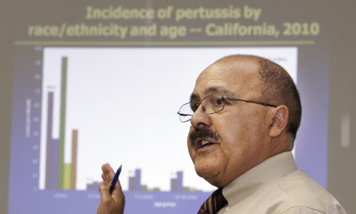 Dr. Juan Ruiz, of the California Department of Public Health, speaks about the 2010 whooping cough outbreak at a news conference by the Centers for Disease Control and Prevention, to publicize a recent, sharp increase in the number of pertussis, or whooping cough, cases reported in California, in Los Angeles on July 15, 2010. (AP Photo/Reed Saxon)