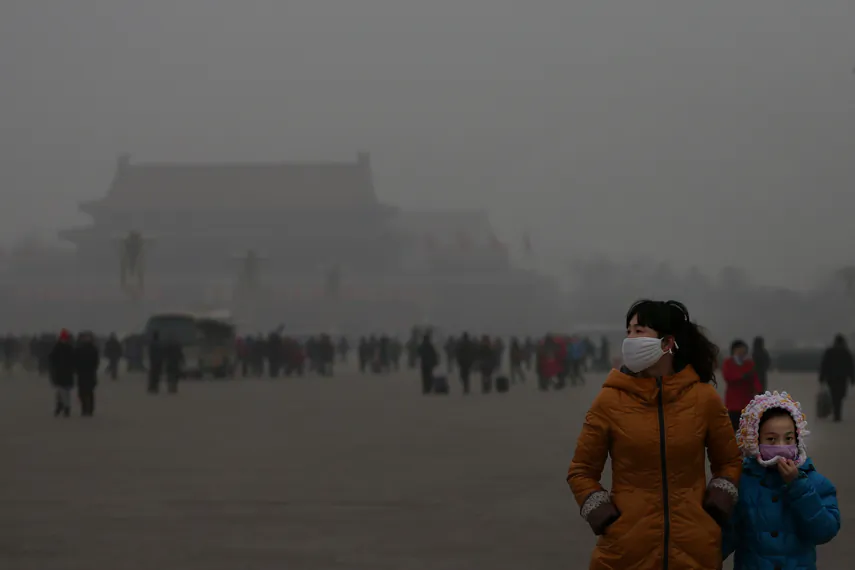 A tourist and her daughter wear masks on Jan. 23 while visiting Tiananmen Square in Beijing. (Feng Li/Getty Images)