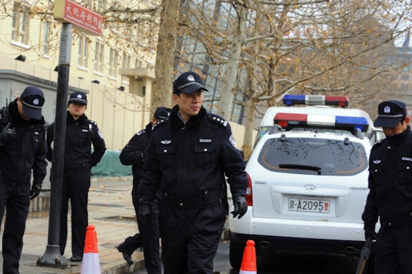 Chinese policemen work at a checkpoint along a street in central Beijing on Feb. 27, 2011. Resignations, corruption investigations, and the pressure of public opinion are getting to the security forces that the Communist Party uses to repress the Chinese people. (Goh Chai Hin/AFP/Getty Images) 