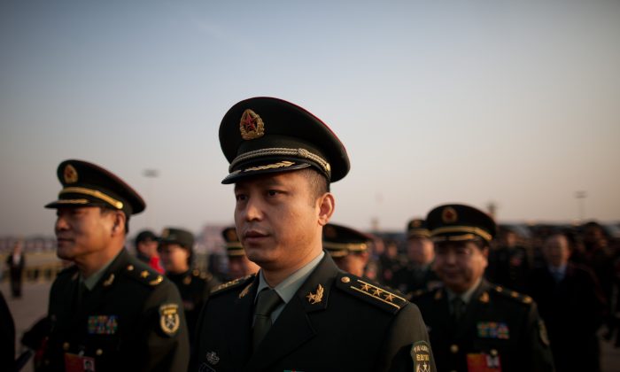 Delegates from the People's Liberation Army (PLA) arrive on Tiananmen Square on March 5. State-sponsored cyberattacks point to the interests of the Chinese military. (Ed Jones/AFP/Getty Images)