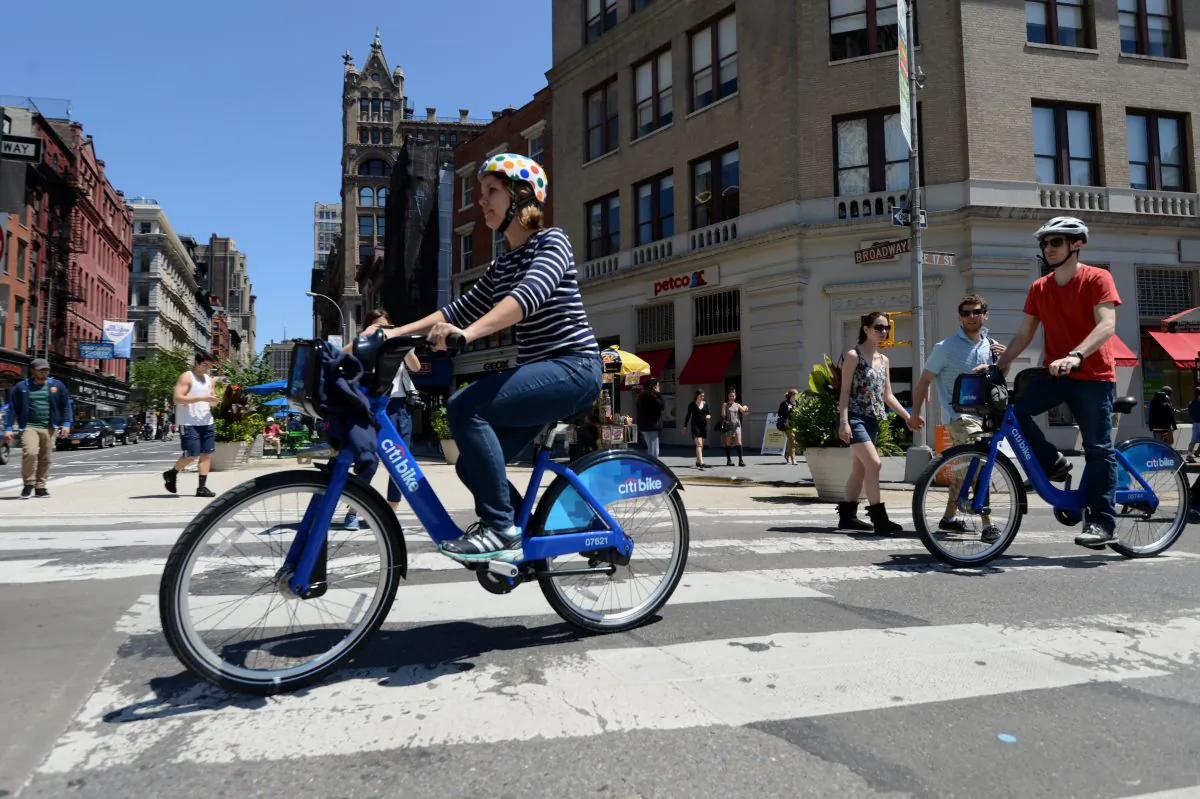 A couple ride their Citi Bike bicycles from a station near Union Square as the bike sharing system is launched in New York on May 27, 2013. (Stan Honda/AFP/Getty Images) 