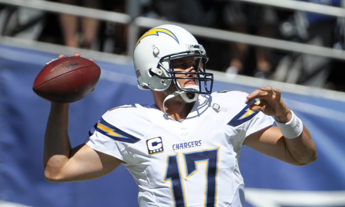 San Diego Chargers quarterback Philip Rivers warms up before an NFL football game against the Dallas Cowboys Sunday, Sept. 29, 2013, in San Diego. (AP Photo/Denis Poroy)