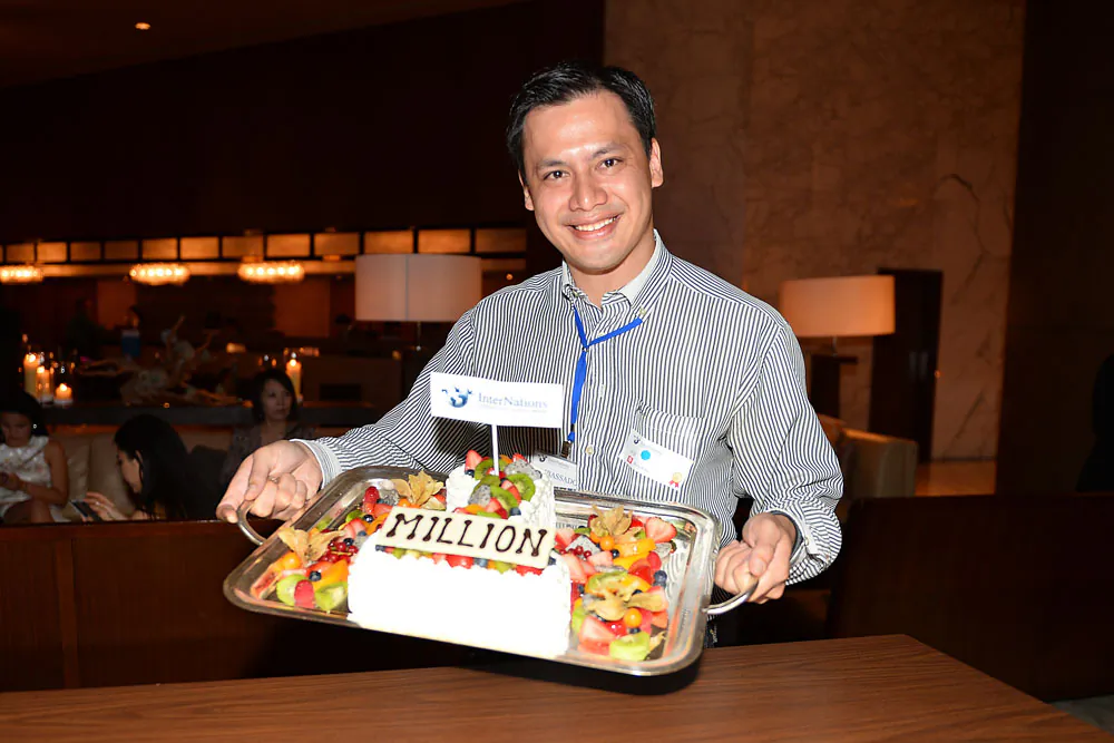 Will Bedoucha InterNations Ambassador holding the one millionth member cake at the celebration party at the Renaissance Harbour View Hotel, Hong Kong on Friday Oct 25, 2013. (Bill Cox/Epoch Times)