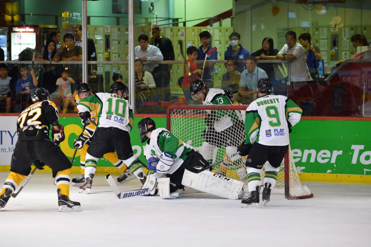 Close match ... Macau Aces players defend in numbers when faced with a tricky problem as three Hong Kong Tycoon’s lurk near the goal. After being tied on 2-all at full time, Aces finally came out on top in extra time in this CIHL match at Mega Ice on Saturday Oct 5, 2013. (Bill Cox/Epoch Times)