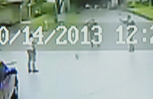 This Oct. 14, 2013 file image from video courtesy of Maurice Bunch shows Bobby Gerald Bennett, left, standing as two Dallas Police officers approach him. Seconds later, Officer Cardan Spencer fires at Bennet who is mentally ill. Spencer has been fired and charged with felony aggravated assault, police said Thursday, Oct. 24, 2013. (AP Photo/Maurice Bunch, File)