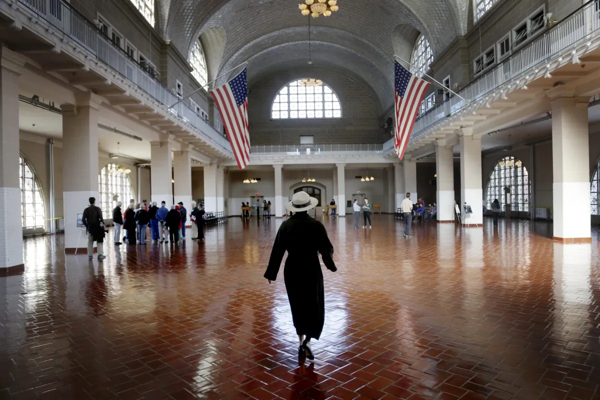 A park ranger walks through the registry room on Ellis Island in New York on Monday, Oct. 28, 2013. (Seth Wenig/AP)