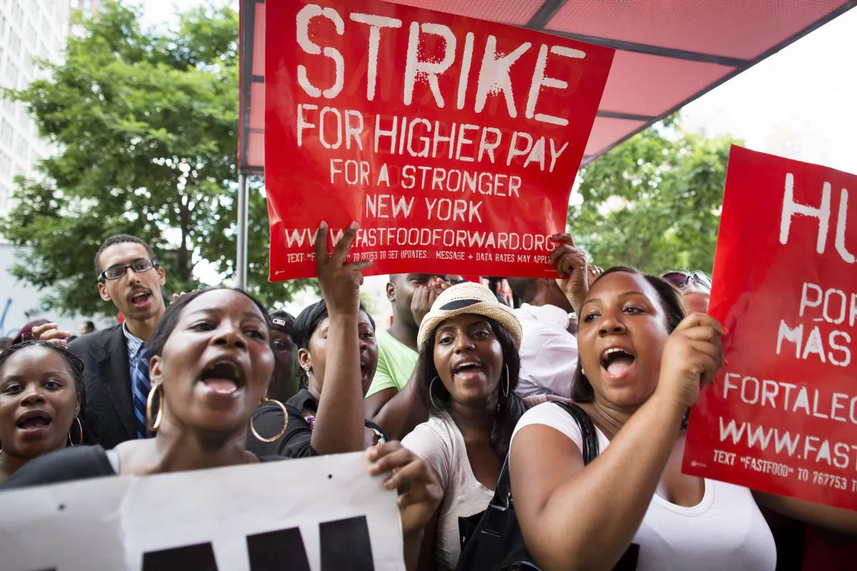 Demonstrators in support of fast-food workers protest outside a McDonald's as they demand higher wages and the right to form a union without retaliation, in New York's Union Square, July 29, 2013. (John Minchillo/AP) 