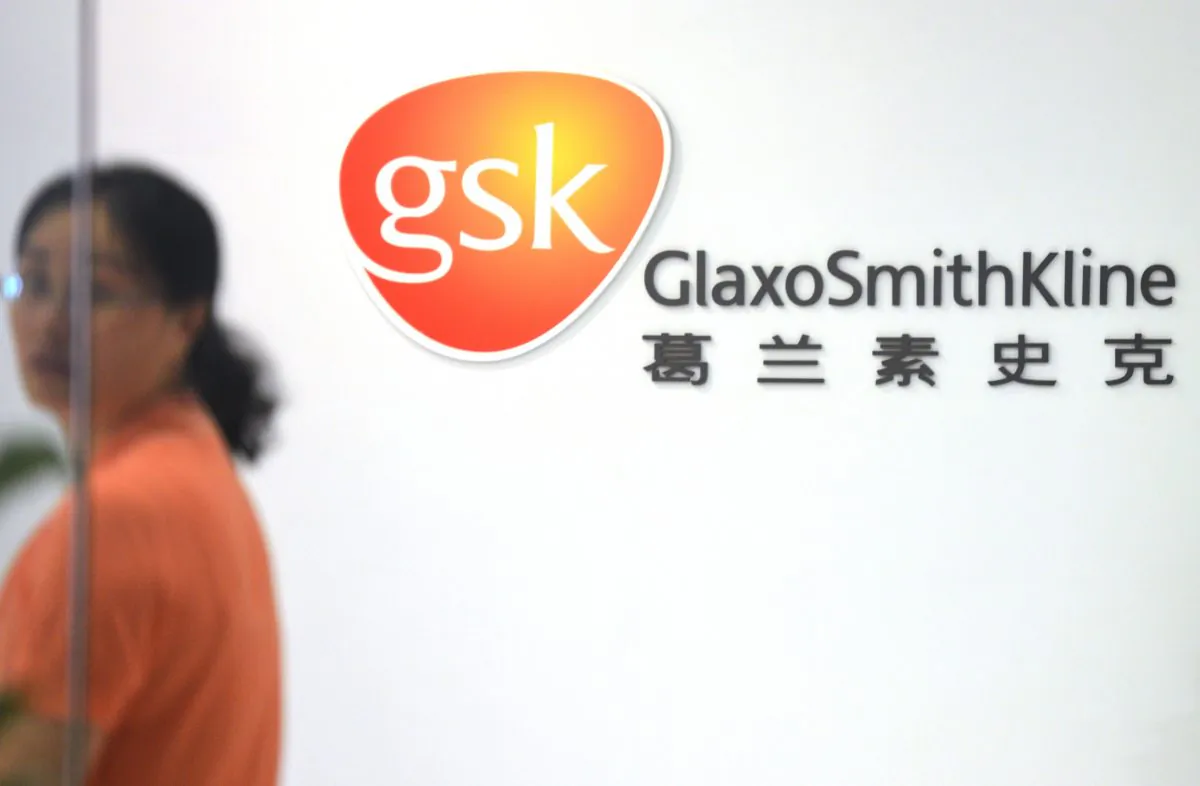 An employee of British drug firm GlaxoSmithKline enters office headquarters in Shanghai on July 1. (Peter Parks/AFP/Getty Images) 