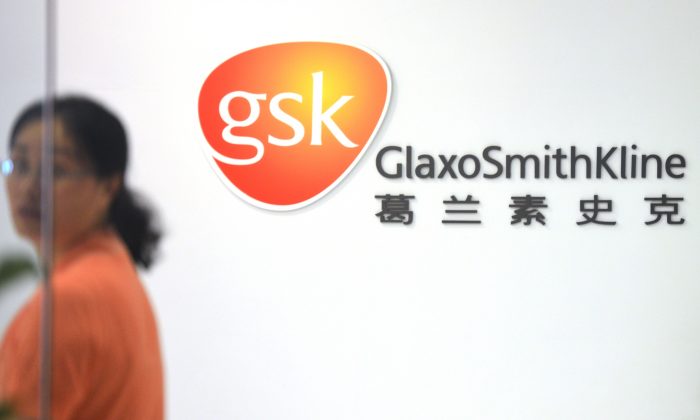 An employee of British drug firm GlaxoSmithKline enters office headquarters in Shanghai on July 1. (Peter Parks/AFP/Getty Images) 