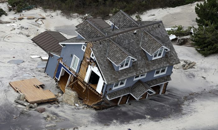 A house along the central Jersey Shore coast was destroyed by Superstorm. New Jersey got the brunt of Sandy, which made landfall in the state on Oct. 29, 2013. (AP Photo/Mike Groll)