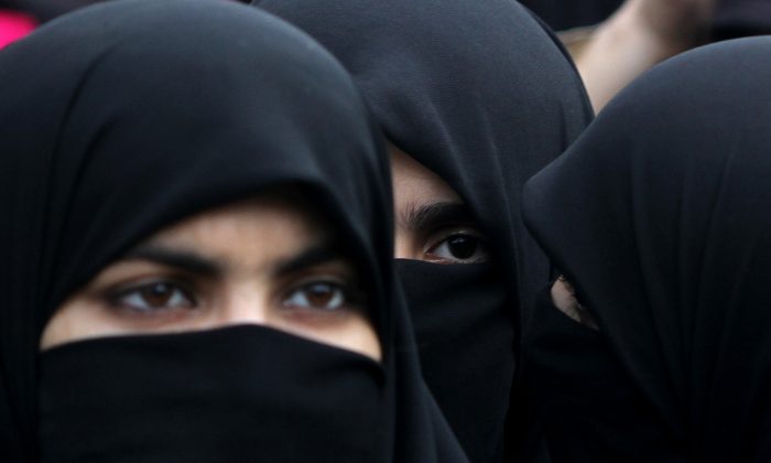 Supporters of Pakistani religious party Jamaat-e-Islami hold a rally to observe the World Hijab (veil) Day in Islamabad, Pakistan, Wednesday, Sept. 4, 2013. A Kuwait Times article published Oct. 12, 2013, explores the hijab requirements at workplaces. (AP Photo/B.K. Bangash) 