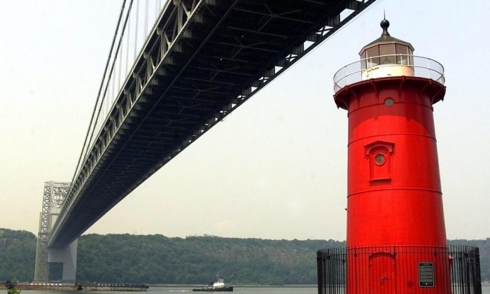 The Jeffrey Hook Lighthouse, which is also called Little Red Lighthouse, sits on the edge of Manhattan Island beneath the span of the George Washington Bridge along the Hudson River in New York, 19 July, 2002. The Little Red Lighthouse Festival this Saturday includes a tour of the lighthouse, readings from the children’s book "The Little Red Lighthouse and the Great Gray Bridge," fishing clinics, live entertainment, food vendors, and other activities at this annual festival. (Matt Campbell/AFP/Getty Images)