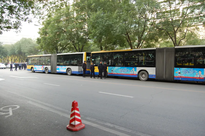 Police buses wait at a Beijing protest on Oct. 21 outside one of China's four major banks. Thousands of laid-off workers at ICBC bank headquarters petitioned banks to rehire them and address inadequate pensions. Protesters were rounded up and taken to a black jail in Beijing. (Courtesy of subjects)