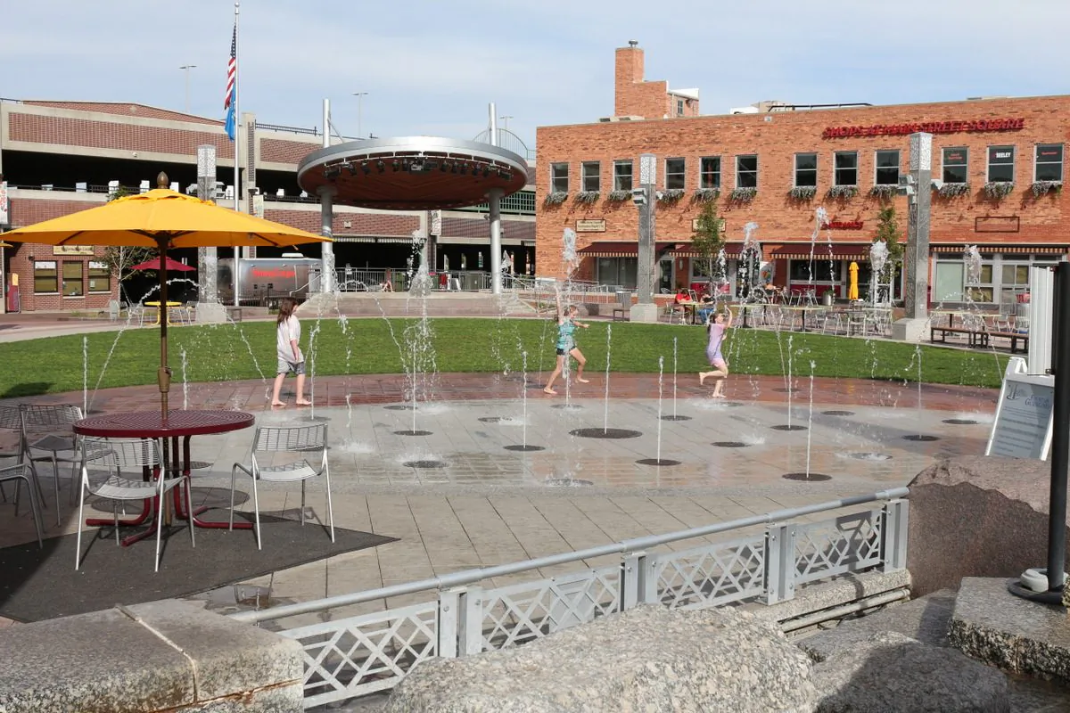 Main Street Square offers concerts and programs on stage in summer, fall fun and an ice skating rink in winter. Kids romp through the water spouts to cool off. (Myriam Moran copyright 2013)