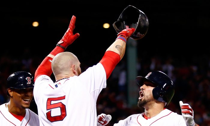 Shane Victorino (R) of Boston celebrates with Jonny Gomes (C) after hitting a grand slam against Jose Veras of Detroit in Game 6 of the ALCS. (Jared Wickerham/Getty Images) 