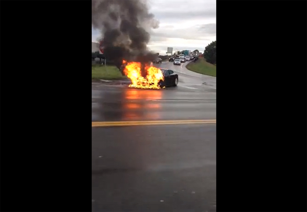 A Tesla Model S catches on fire on a highway near Seattle (Screenshot via Youtube)