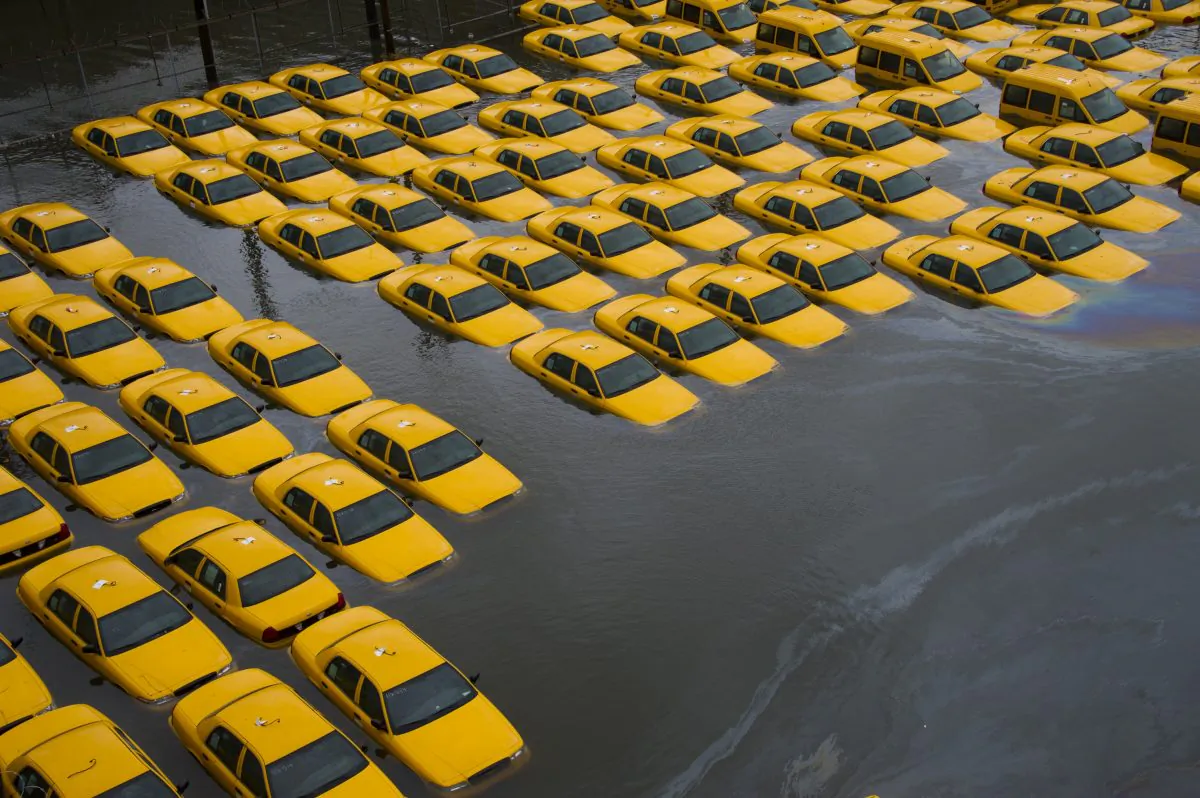 A parking lot full of yellow cabs is flooded as a result of Superstorm Sandy, in Hoboken, N.J., Oct. 30, 2012. (AP Photo/Charles Sykes)