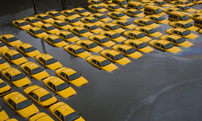 A parking lot full of yellow cabs is flooded as a result of Superstorm Sandy, in Hoboken, N.J., Oct. 30, 2012. (AP Photo/Charles Sykes)