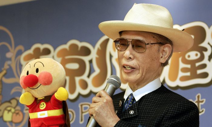Holding a glove puppet of Anpanman, Japanese cartoonist Takashi Yanase delivers his speech during the opening ceremony of the Tokyo Panya Street, a theme park at the Tokyo-Bay Lalaport shopping mall in Funabashi, eastern outskirts of Tokyo, on Feb. 22, 2005.(Toshifumi Kitamura/AFP/Getty Images)