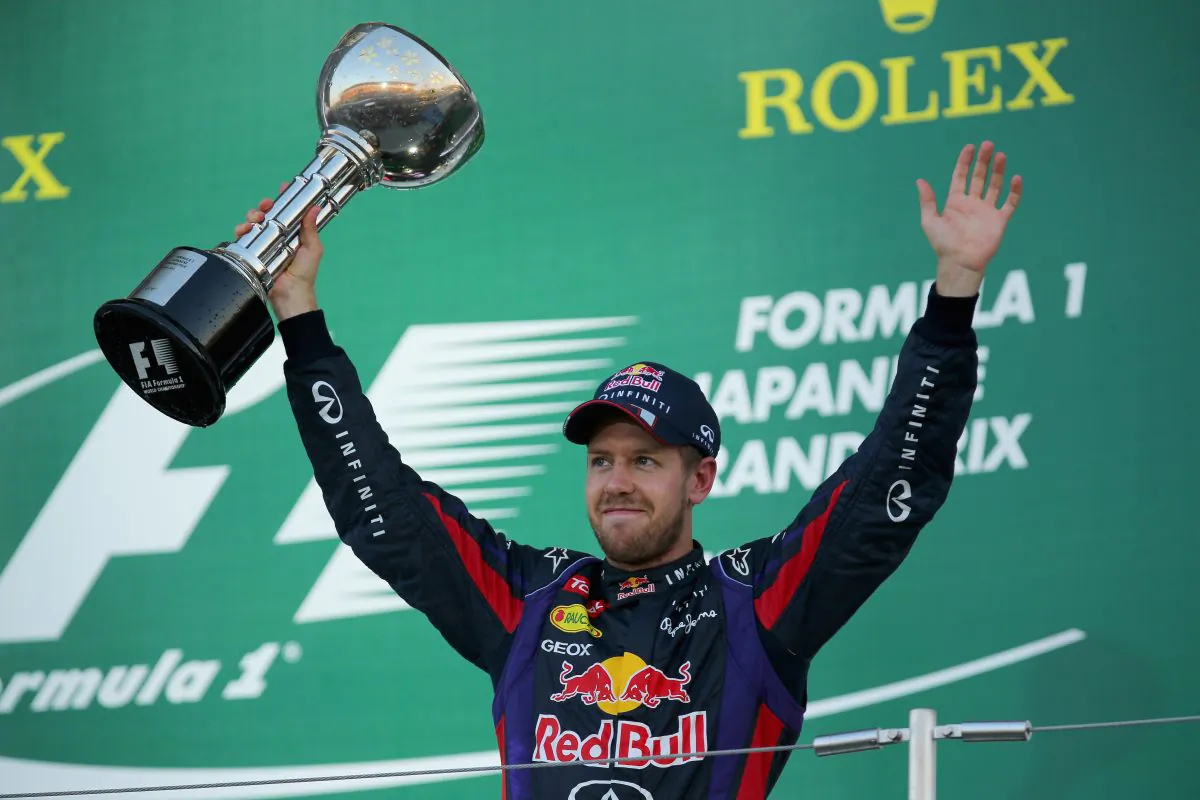 Sebastian Vettel of Red Bull Racing celebrates on the podium after winning the Formula One Japanese Grand Prix at Suzuka Circuit on October 13, 2013 in Suzuka, Japan. (Clive Rose/Getty Images)