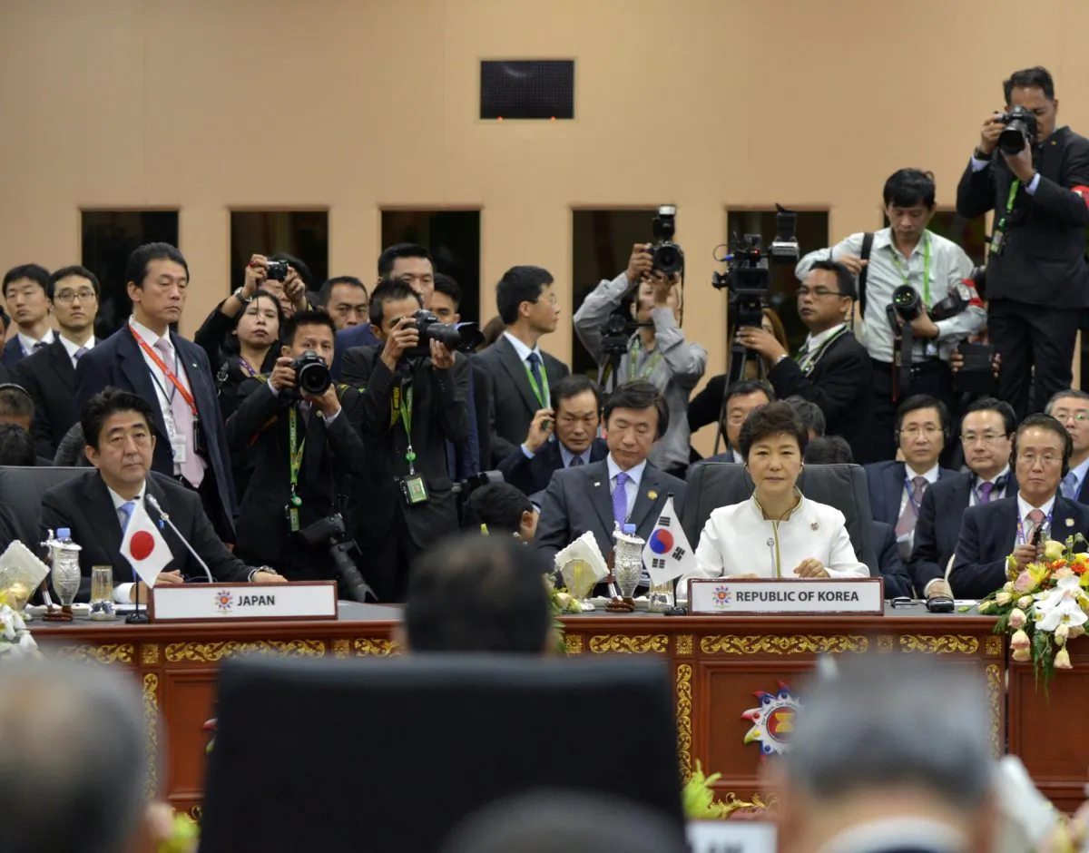 Japanese Prime Minister Shinzo Abe (L) and South Korean President Park Geun-hye (C) at the 16th ASEAN Plus Three (China, Japan, South Korea) summit on Oct. 10. (Philippe Lopez/AFP/Getty Images)
