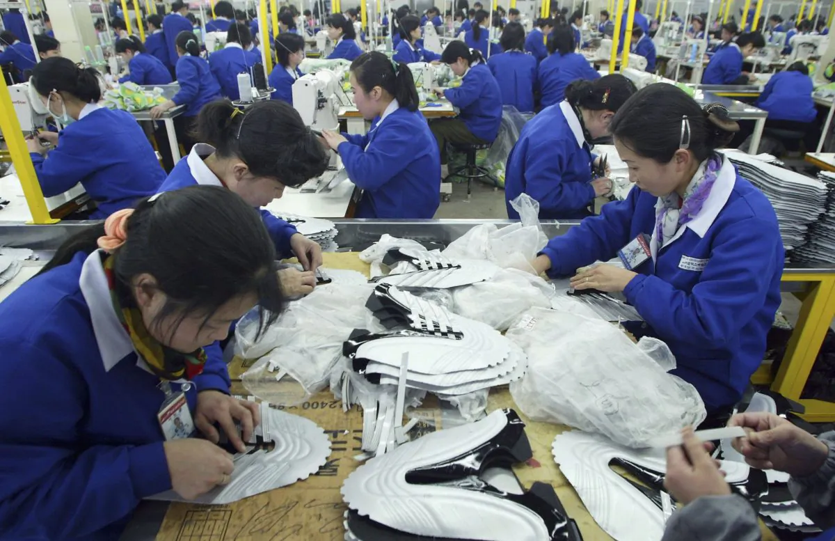 North Korean women work at the assembly line of the factory of shoemaker Samduk Inc. at the Kaesong industrial complex in Kaesong, North Korea, on Feb. 27, 2006. An article published Oct. 6, 2013, in the Korean Herald looked at a Korean man who has been hand-crafting shoes for 60 years and the history of shoemaking in Korea. (Chung Sung-Jun/Getty Images)