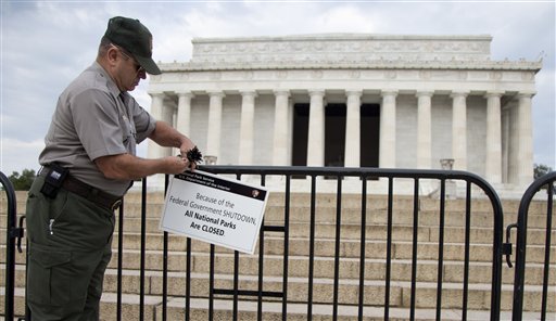 A National Park Service employee posts a sign on a barricade to close access to the Lincoln Memorial in Washington, Tuesday, Oct. 1, 2013. (AP Photo/Carolyn Kaster)