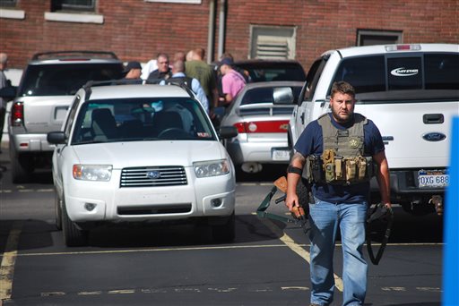 U.S. Deputy Marshall Chad Simpson walks near the Federal Building in Wheeling, W.Va, on Wednesday, Oct. 9, 2013. West Virginia State Police say a man who fired shots at a federal courthouse in Wheeling has died from police fire. State police spokesman Sgt. Michael Baylous confirmed that the man died Wednesday. The U.S. Marshals Services says officers fired at the man after he shot up to two dozen rounds at the courthouse. (AP Photo/Wheeling News Register & The Intelligencer, Scott McCloskey)