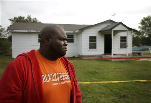 Terrence Walker of Forney, Texas, the brother of 36-year-old Charles Everett Brownlow Jr., stands in front of their mother, Mary Brownlow's house as he answers a reporters question, Tuesday, Oct. 29, 2013, in Terrell, Texas. Police arrested Charles Everett Brownlow Jr. early Tuesday who is suspected of killing five people, including his mother, during a series of attacks hours earlier in his rural North Texas community. Mary Brownlow,was found dead Monday evening in the house where a fire was set and very clearly an arson, according to authorities. (AP Photo/Tony Gutierrez)