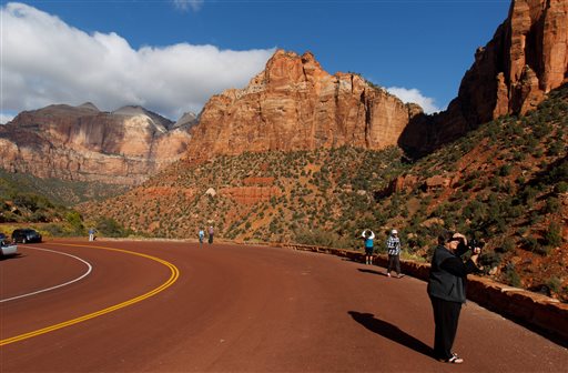 Visitors to Zion National Park take in the sights after the park opened on a limited basis Friday, Oct. 11, 2013 near Springdale, Utah. (AP Photo/The Salt Lake Tribune, Trent Nelson)
