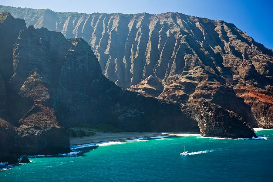 Sailing along the Napali coast on the island of Kauai in Hawaii. With some creativity and savvy shopping, planning a dream vacation to Hawaii and other destinations can be done for much cheaper than one might expect. (Hawaii Tourism Authority (HTA) / Tor Johnson)