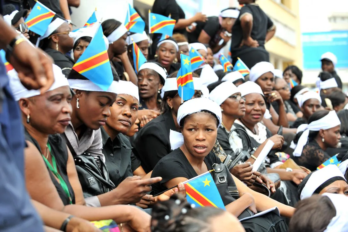 Congolese women wearing a white headband and holding Congolese flags stage a demonstration asking for peace in the east of the country, Kinshasa, DR Congo, on Nov. 23, 2012. (Junior D. Kannah/Getty Images)