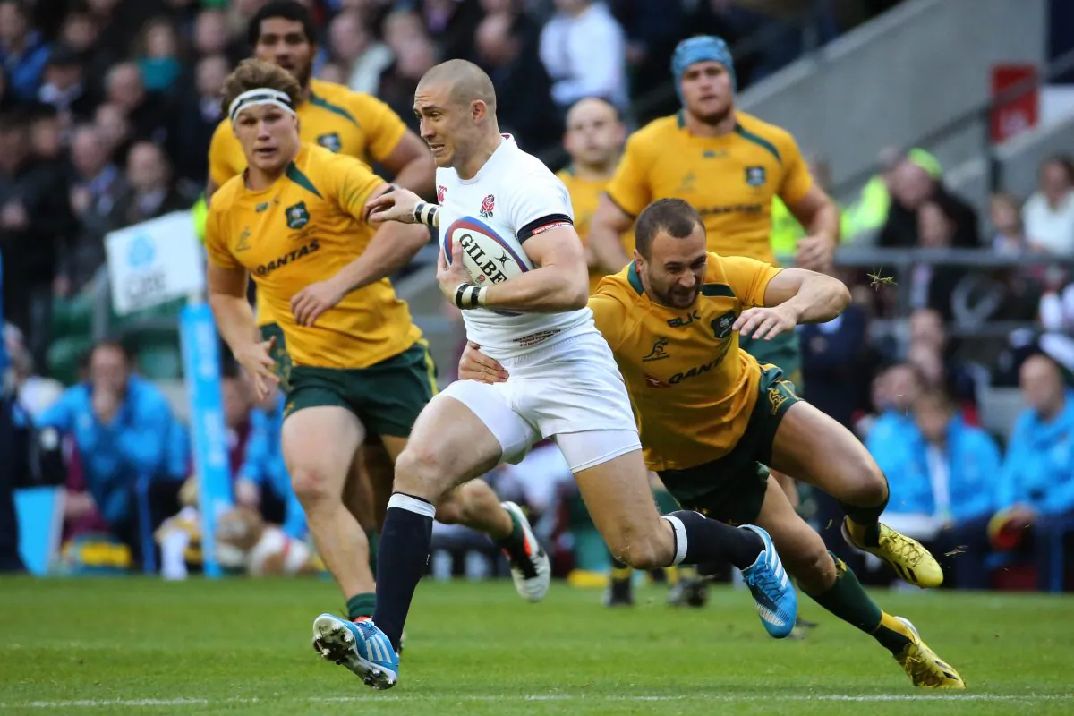 Man-of-the-Match ... Mike Brown of England is tackled by Quade Cooper of Australia during their match at Twickenham Stadium on Nov 2, 2013. (Warren Little/Getty Images)