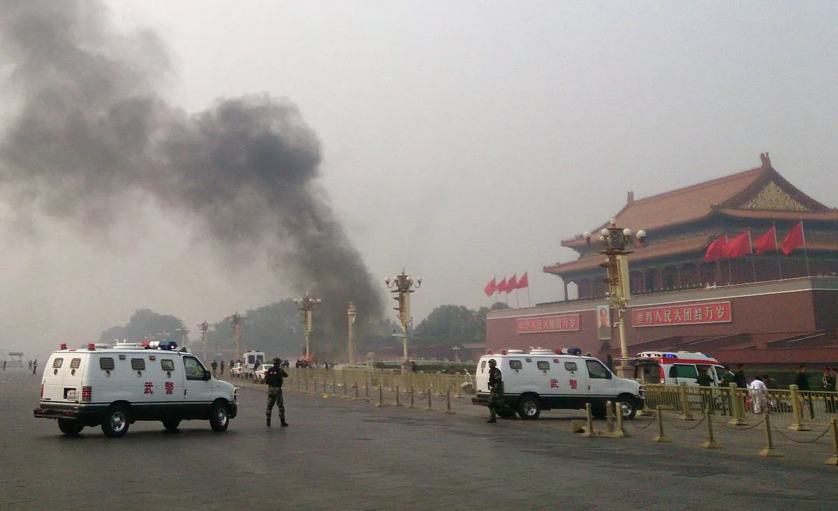 Police cars block off the roads leading into Tiananmen Square as smoke rises into the air after a vehicle crashed in front of Tiananmen Gate in Beijing on Oct. 28, 2013. The car was driven by a Uyghur, and Uyghurs fear this incident will be used by the Chinese regime to justify harsh suppression. (STR/AFP/Getty Images) 